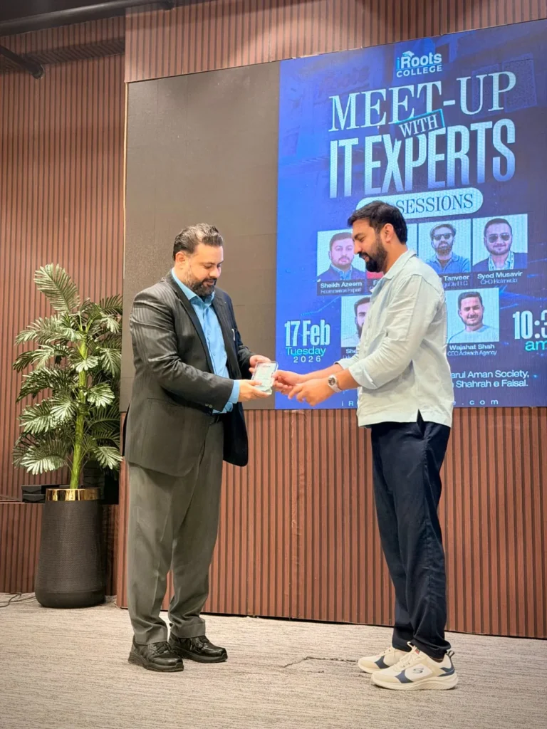 Usama Tanveer receiving a shield at the iRoots College IT experts meetup