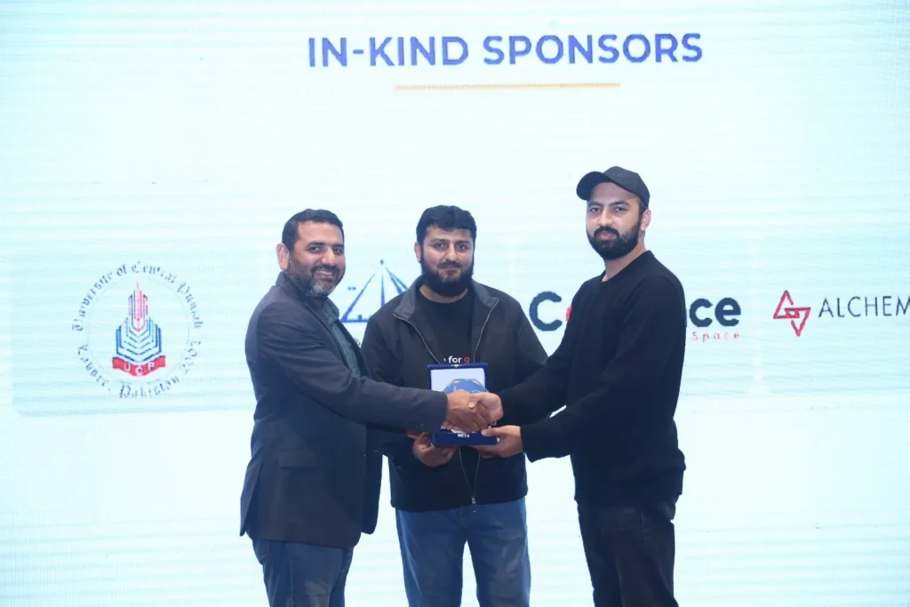 Usama Tanveer receiving a speaker shield at WordCamp Lahore